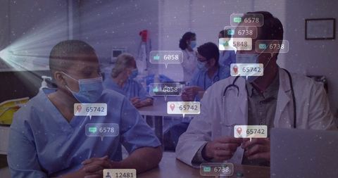 Medical team collaborating and reviewing cases during staff briefing with digital notifications