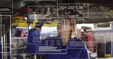 Female mechanic inspecting undercarriage with augmented diagnostics overlay