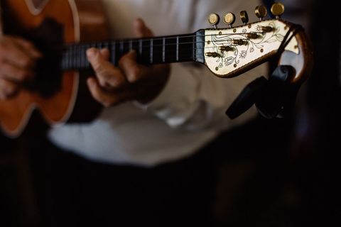 Close-Up of Musician Playing Acoustic Guitar with Beautiful Headstock