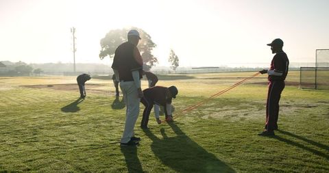 Baseball team in early morning fitness and drills