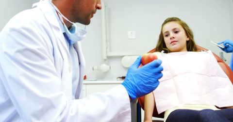 Dentist Promoting Healthy Eating for Oral Hygiene with Young Patient - Download Free Stock Images Pikwizard.com