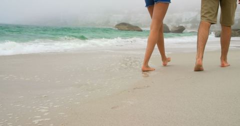 Close-Up of Couple Strolling Along Serene Beach Destination - Download Free Stock Images Pikwizard.com