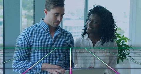 Business Colleagues Collaborating by Window Overlooking City