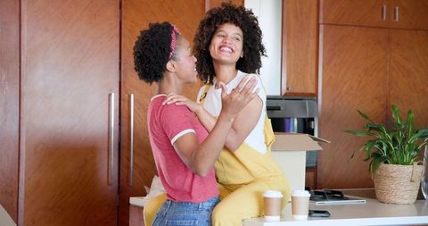 Happy Lesbian Couple Enjoying Morning Together in Kitchen