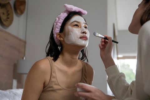 Female Friends Enjoying Skincare Routine with Facial Mask