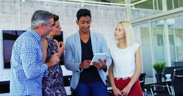 Multiracial Business Team Discussing Digital Report on Tablet - Download Free Stock Images Pikwizard.com