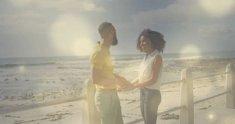 Romantic Couple Holding Hands at Beach Promenade in Soft Light