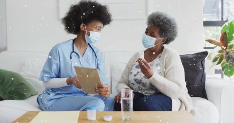 Nurse Listening to Senior at Home for Healthcare Consultation
