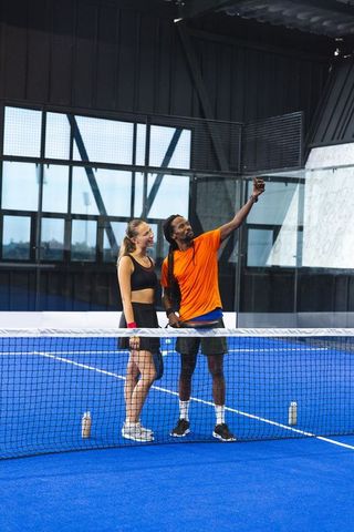 Diverse Friends Taking Selfie on Padel Court Demonstrating Team Spirit