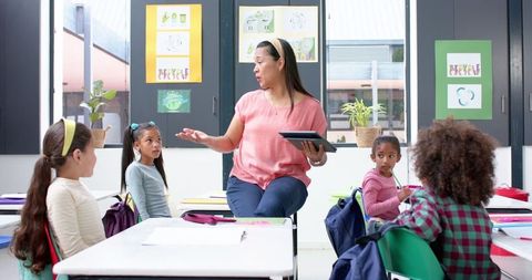 Teacher Using Tablet in Elementary Classroom for Digital Lesson