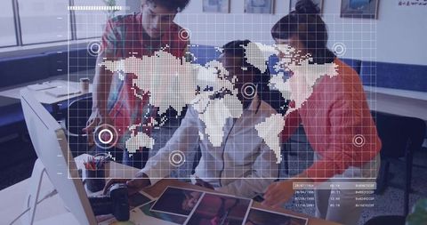 Creative team reviewing dslr prints with world map hud overlay and collaborative workflow