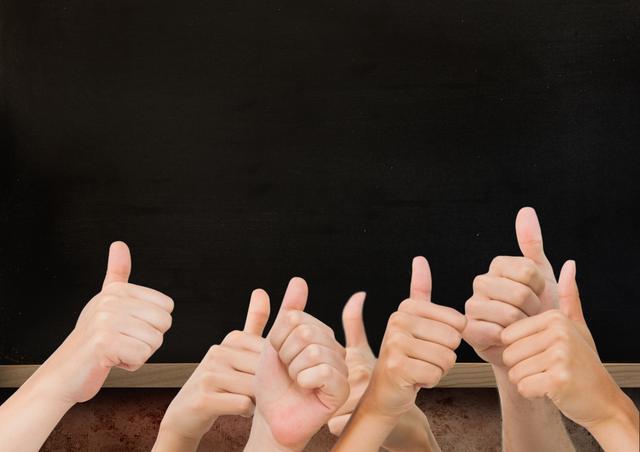 Image shows several hands giving thumbs up in front of a blackboard. Ideal for concepts related to education, teamwork, success, and positivity. Can be used in educational materials, motivational posters, team-building presentations, and promotional content highlighting collaboration and support.