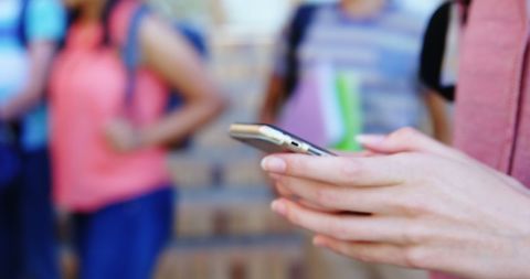Schoolgirl Using Mobile Phone in Campus Environment - Download Free Stock Images Pikwizard.com