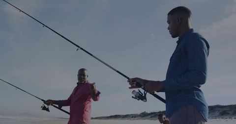 Casting Lines on Sandy Beach Trio Fishing Together with Spinning Reels
