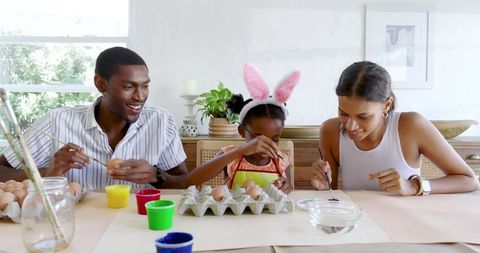 Family Enjoying Easter Egg Painting at Home