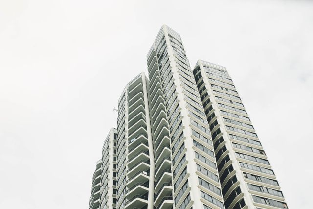 High-rise Apartment Building Against Cloudy Sky - Download Free Stock Photos Pikwizard.com