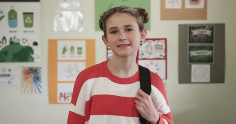 Youth Girl Inspiring Environmental Awareness in School Hallway