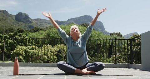 Senior Woman Practicing Mindful Yoga on Outdoor Terrace