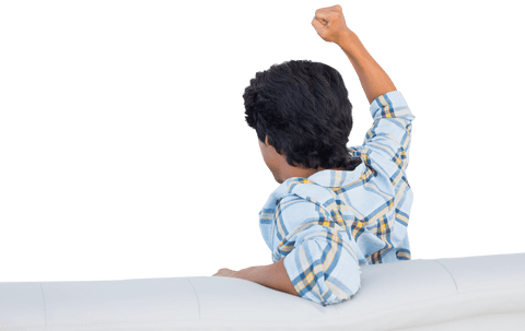 Excited Fan Cheering with Clenched Fist on Couch