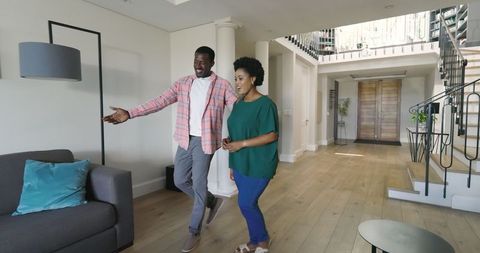 Friends Sharing Joyful Moment in Modern Home Entrance Hallway