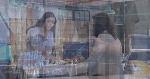 Businesswomen Collaborating on Digital Data Analysis in Modern Office