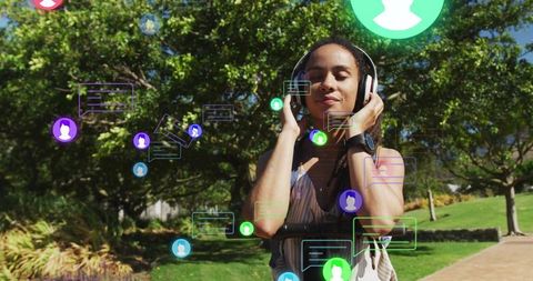 Young woman enjoying music outdoors amid digital connections