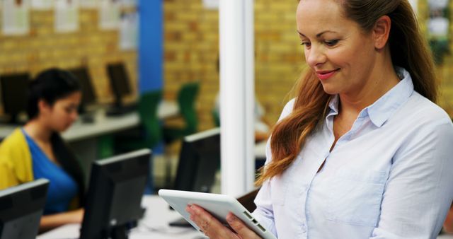 Smiling Woman Using Tablet in Office Setting - Download Free Stock Images Pikwizard.com