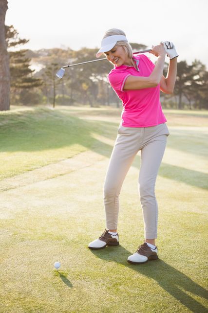 Sportswoman playing golf on a field