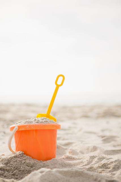 Bucket with sand and a spade on beach - Download Free Stock Photos Pikwizard.com