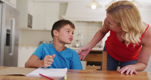 Caucasian mother helping her son with his homework at home - Download Free Stock Photos Pikwizard.com