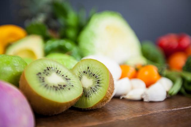 This vibrant close-up captures a variety of fresh fruits and vegetables on a table, highlighting the freshness and natural colors. Ideal for use in diet and nutrition articles, healthy eating blogs, recipes, and food-related marketing materials.