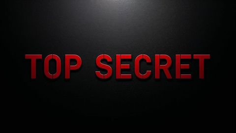 Illuminating top secret red 3d letters on matte black wall with dramatic spotlight and seams