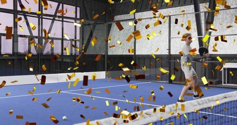 Padel player celebrating winning shot on blue indoor court with golden confetti