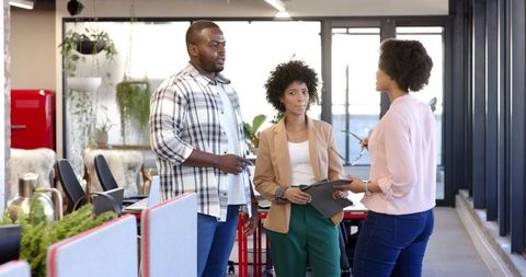 Diverse Colleagues Collaborating on Business Strategies in Modern Office