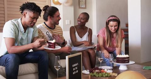 Friends Celebrating New Job with Cake and Laughter at Home