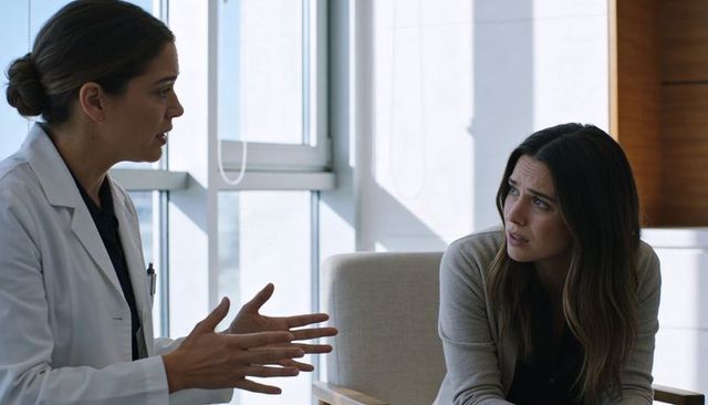 Female doctor explaining treatment options to concerned woman in bright clinic