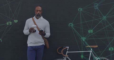 African American Man Using Smartphone Overlaid with Digital Network Icons