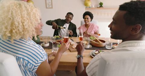 Joyful Gathering Having Wine and Salad at Home Celebration