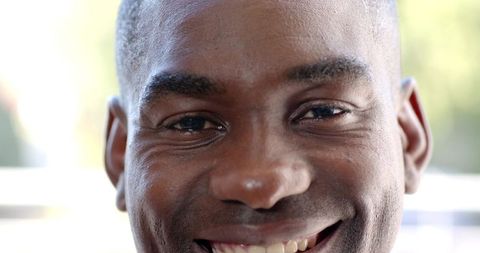 African american man smiling closeup showing teeth and laugh lines in natural light