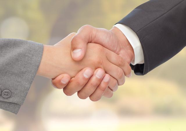 This image shows a close-up of two businesspeople shaking hands, symbolizing agreement, partnership, and successful collaboration. It can be used in business presentations, websites, and marketing materials to convey themes of trust, cooperation, and professional relationships.