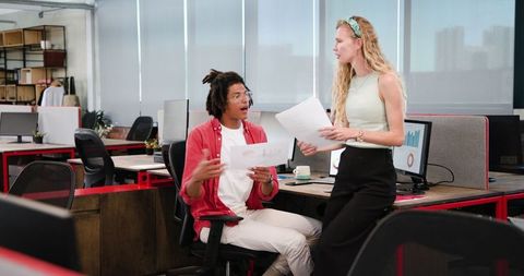 Colleagues collaborating on project at office workspace