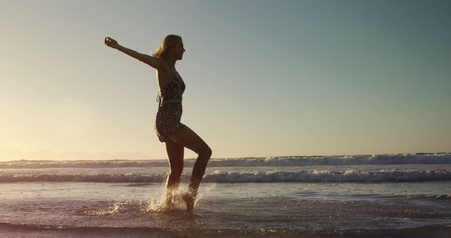 Young Woman Enjoying Sunny Day at Beach During Sunset - Download Free Stock Images Pikwizard.com