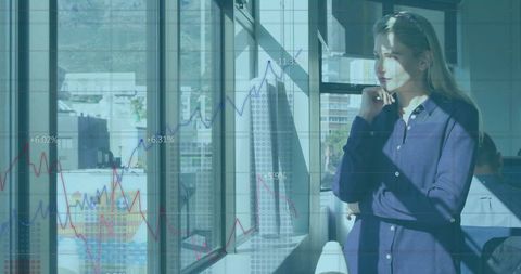 Woman Analyzing Stock Market Trends through Office Window