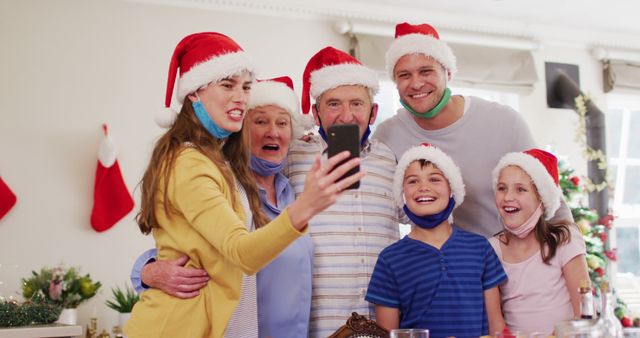 Family Celebrating Christmas Together with Santa Hats and Masks - Download Free Stock Images Pikwizard.com