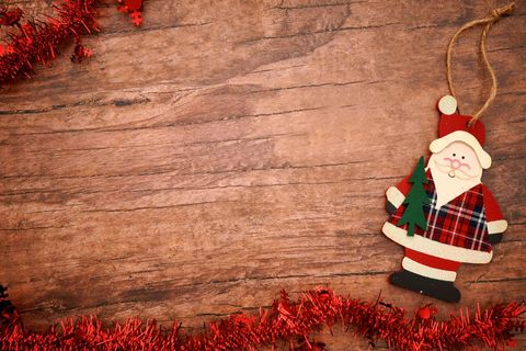 Christmas santa ornament on rustic wooden background