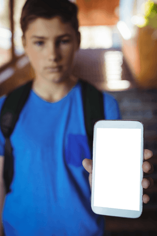 Schoolboy Holding Phone with Transparent Black Screen Outdoors - Download Free Stock Videos Pikwizard.com