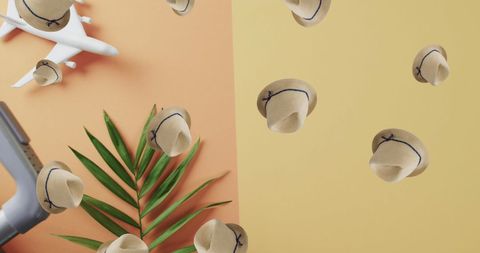 Falling Sunhats and Plane Model on Colorful Backdrop
