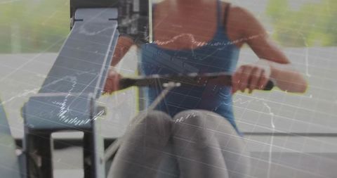 Woman Exercising on Rower Machine with Live Fitness Data Display