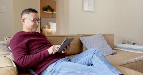 Senior Man Engaged with Tablet in Cozy Living Room