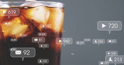 Cold cola glass featuring ice, condensation and floating social media notification overlays